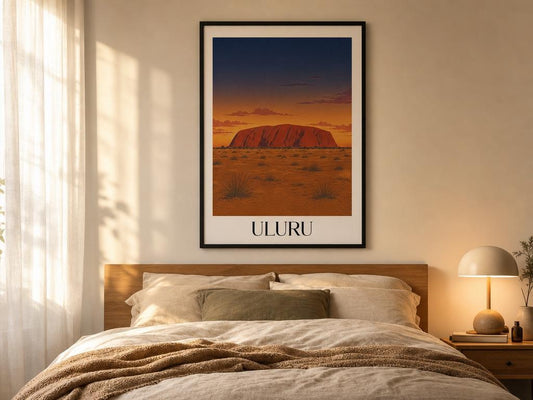 Framed artwork of Uluru on a wall above a bed in a bedroom.