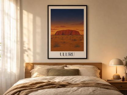 Framed artwork of Uluru on a wall above a bed in a bedroom.